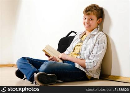 teenager boy is making a homework at school