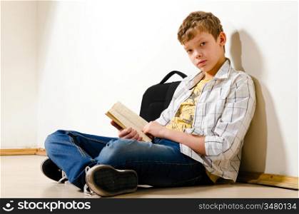 teenager boy is making a homework at school