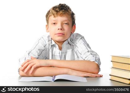 teenager boy is sitting at table on white background