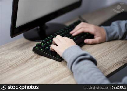 teenager boy playing computer close up