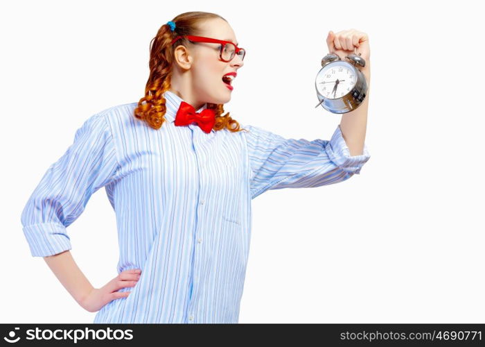 Teenager girl holding alarm clock. Teenager girl in red glasses holding alarm clock