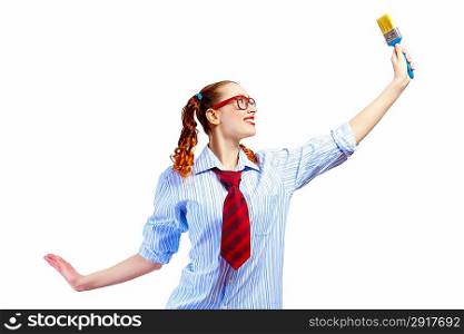 Teenager girl holding paintbrush