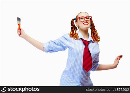 Teenager girl holding paintbrush. Image of funny teenager girl holding paintbrush