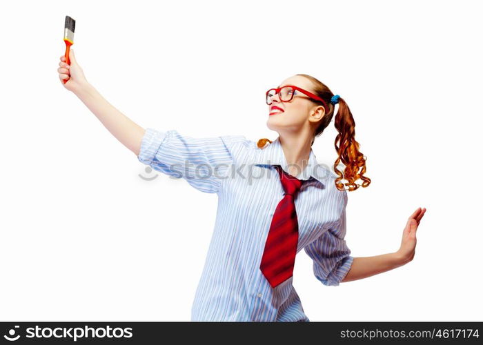 Teenager girl holding paintbrush. Image of funny teenager girl holding paintbrush