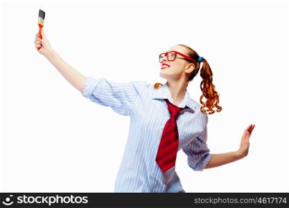 Teenager girl holding paintbrush. Image of funny teenager girl holding paintbrush