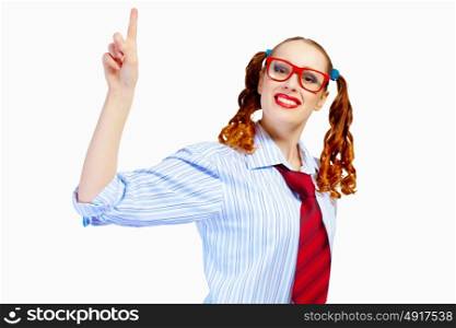 Teenager girl in red glasses. Image of pretty teenager girl in red glasses pointing with finger