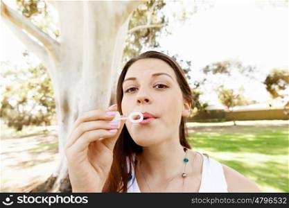 Teenager girl in the park. Teenager girl in the park blowing bubbles