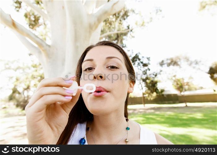 Teenager girl in the park. Teenager girl in the park blowing bubbles