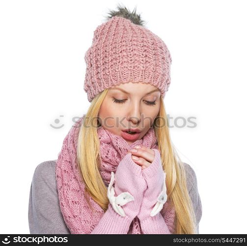 Teenager girl in winter hat and scarf warming hands