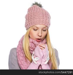 Teenager girl in winter hat and scarf warming hands