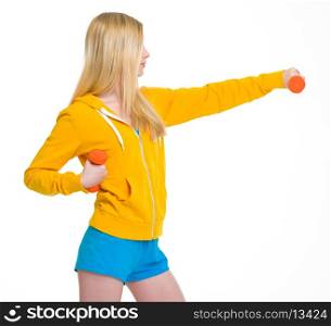 Teenager girl making exercise with dumbbells
