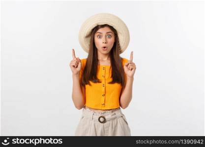 Teenager girl on summer vacation surprised and pointing finger on copy space over isolated white background. Teenager girl on summer vacation surprised and pointing finger on copy space over isolated white background.