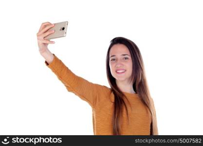 Teenager girl taking a selfie with her mobile isolated on a white background
