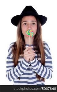 Teenager girl with a colorful lollipop on her mouth isolated on a white background