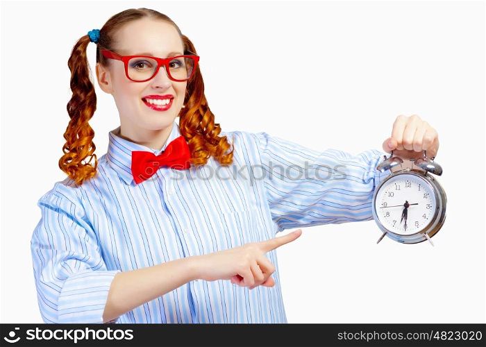 Teenager girl with alarm clock. Happy teenager girl in red glasses holding alarm clock