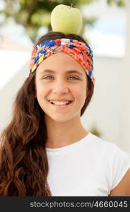 Teenager girl with blue eyes and a apple on her head