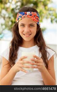 Teenager girl with blue eyes drinking milk glass