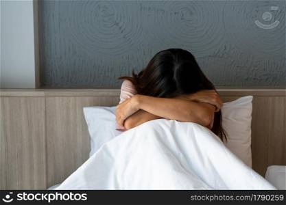 Teenager girl with depression sitting alone on bed. sad, unhappy, disappointed concept