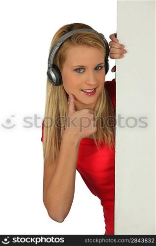 Teenager giving with headphones giving thumbs-up sign