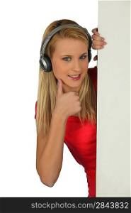 Teenager giving with headphones giving thumbs-up sign