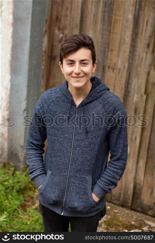 Teenager guy with a wooden door of background
