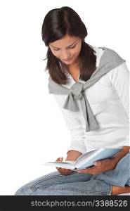 Teenager holding book and reading on white background