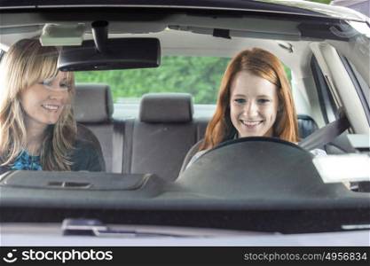 Teenager in car with driving instructor