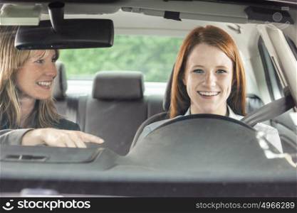 Teenager in car with driving instructor