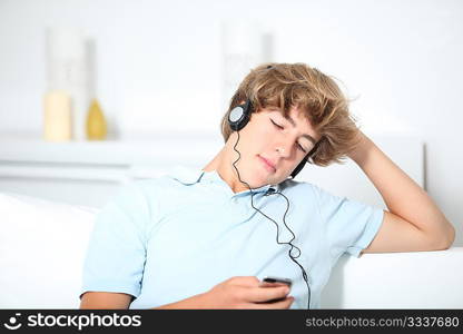 Teenager listeing to music in sofa