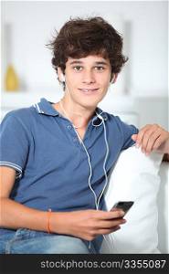 Teenager listening to music with mp3 player
