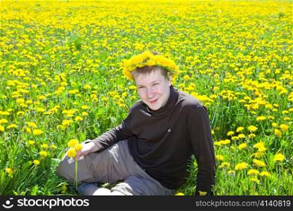 Teenager on meadow with dandelions