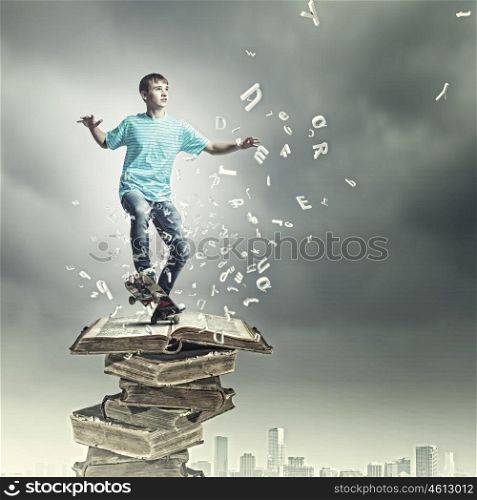 Teenager on skateboard. Boy skater standing on pile of old books