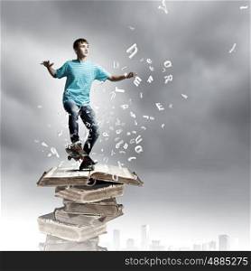 Teenager on skateboard. Boy skater standing on pile of old books