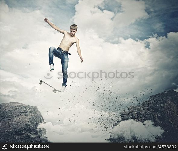 Teenager on skateboard. Skater in jeans jumping over mountain gap