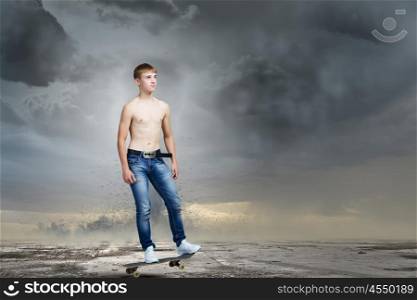 Teenager on skateboard. Skater in jeans on road with tornado at background