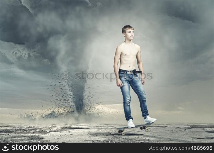Teenager on skateboard. Skater in jeans on road with tornado at background