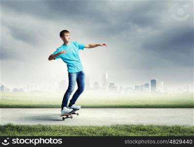 Teenager on skateboard. Skater in jeans riding on road against city background
