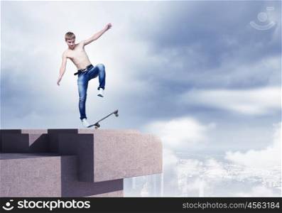 Teenager on skateboard. Skater in jeans riding on top of building