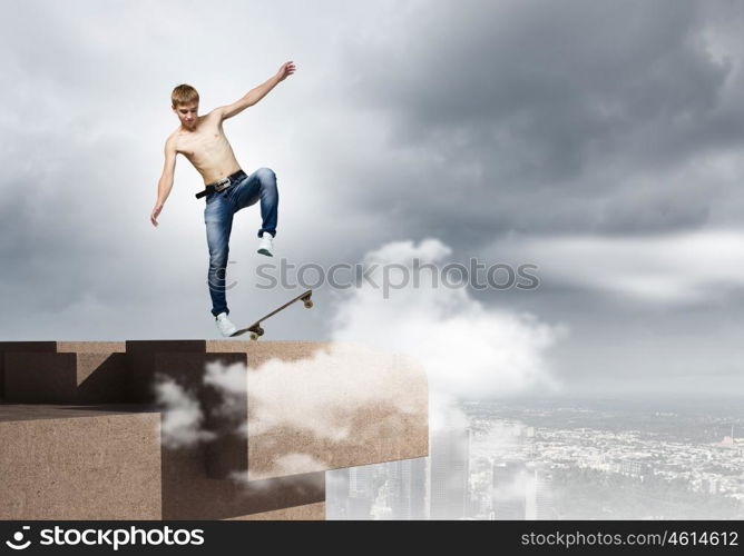 Teenager on skateboard. Skater in jeans riding on top of building