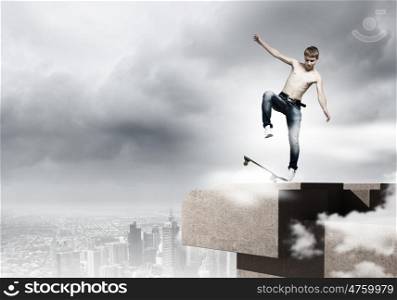 Teenager on skateboard. Skater in jeans riding on top of building