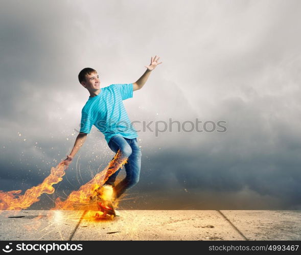 Teenager on skateboard. Skater in jeans riding on top of building