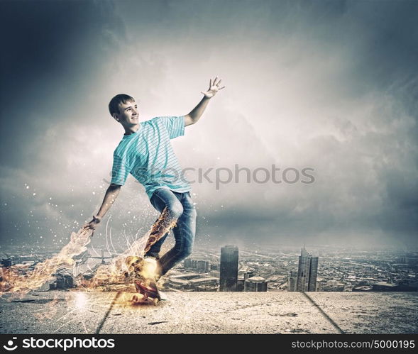 Teenager on skateboard. Skater in jeans riding on top of building