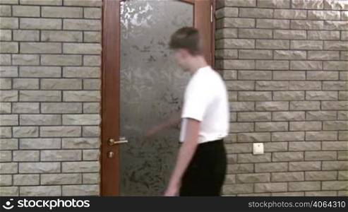 teenager opens door and enters into bathroom.
