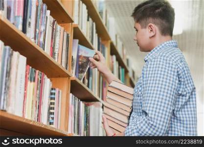 teenager picking books from shelf