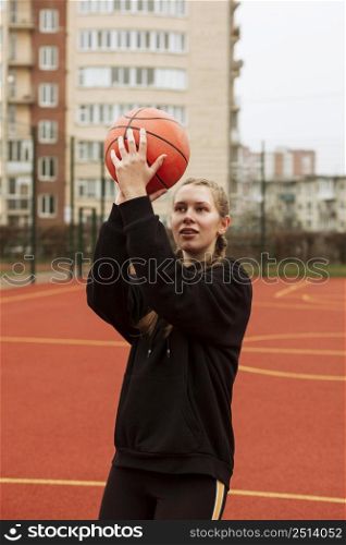 teenager playing basketball outdoors 2