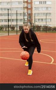 teenager playing basketball outdoors