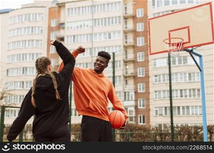 teenager playing basketball together