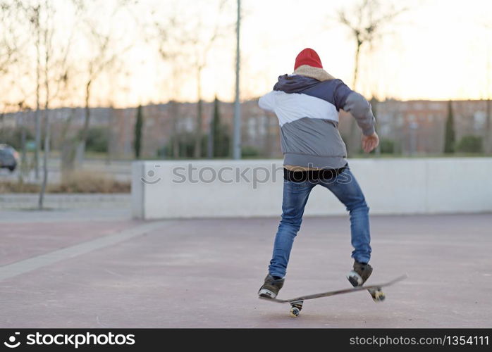 teenager practicing with skateboard at sunrise city