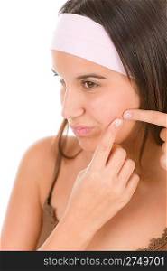 Teenager problem skin care - woman squeeze pimple on white background