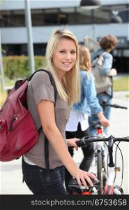 Teenager pushing bike